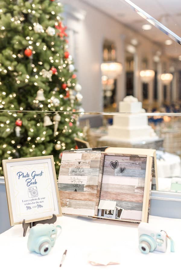 White table with weathered wood sign and two mint blue Polaroid cameras