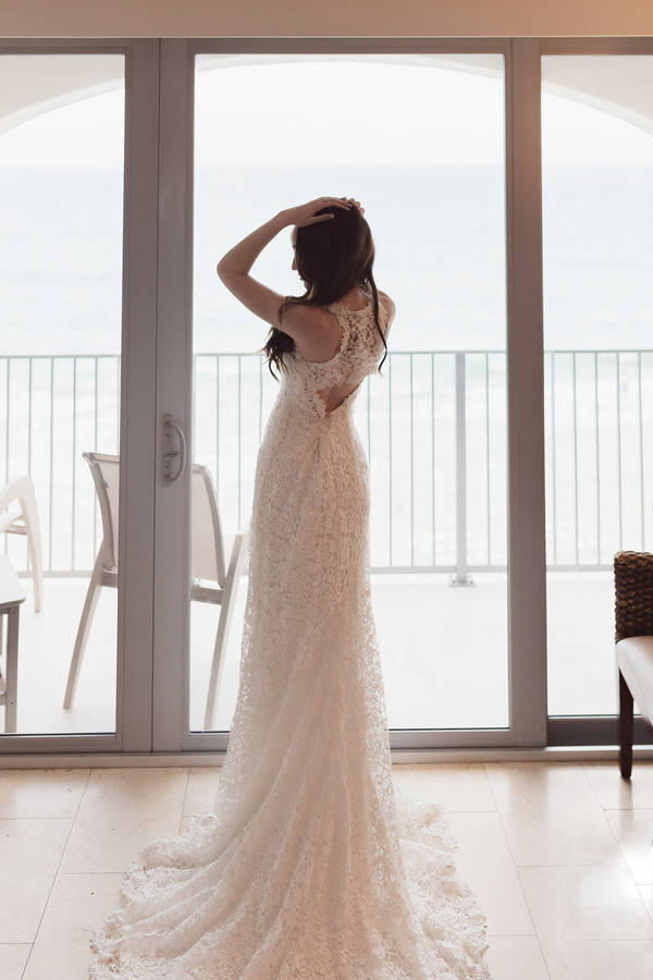 Bride posing showing fitted gown with cut-out back detail