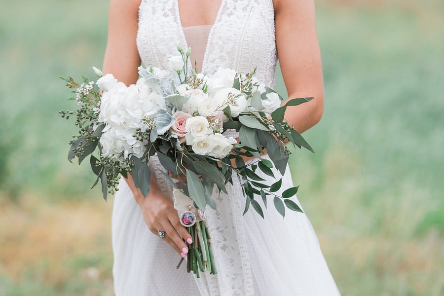 Bridal bouquet closeup with rose gold locket