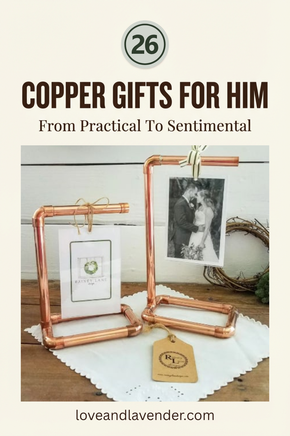 Two copper pipe photo holders display pictures on a table, with a gift tag and wreath in the background. Text reads "26 Copper Anniversary Gifts for Him—From Practical to Sentimental.