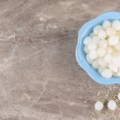 Peeled cloves of garlic placed on a stone table