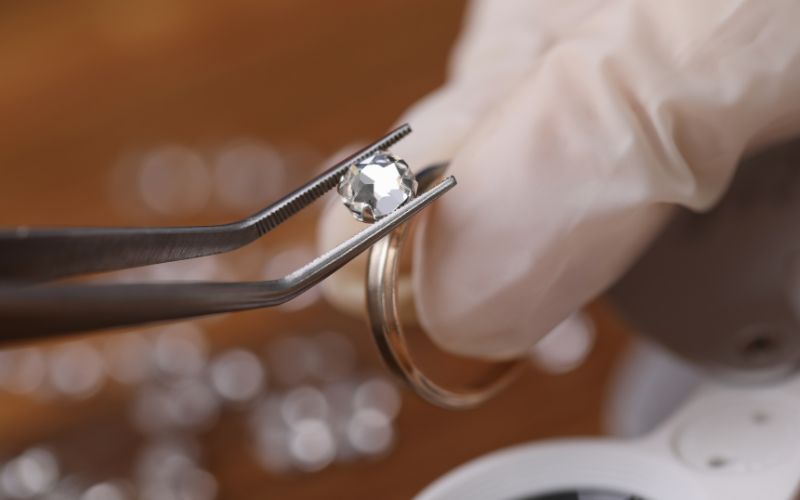 Loose cut Mossanite being prepared for installation on a ring