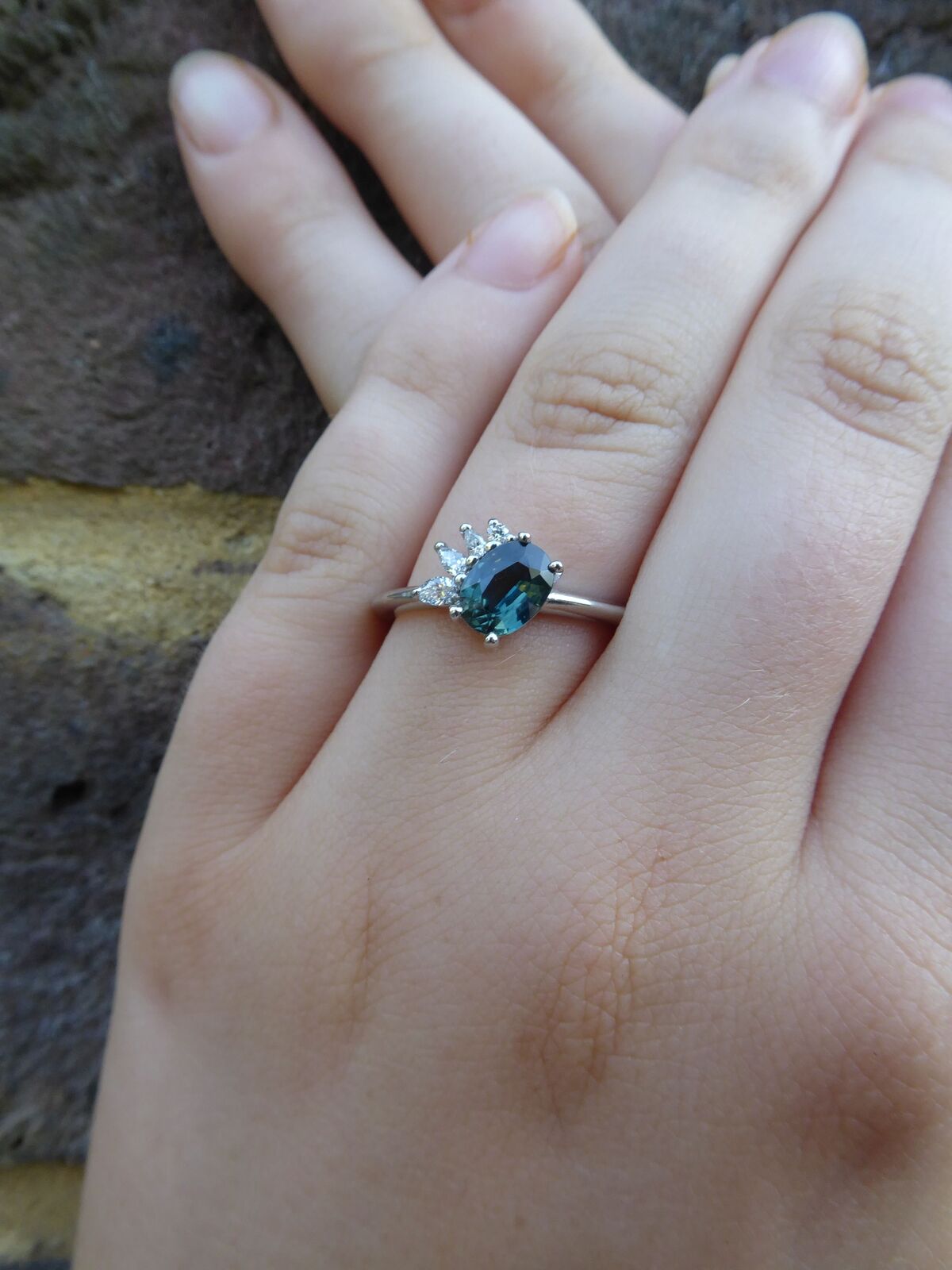 Teal Sapphire and diamonds Selene engagement ring on hand