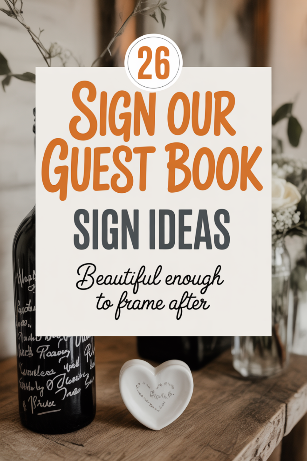 A sign reads “26 Sign Our Guest Book Sign Ideas - Beautiful enough to frame after,” with a decorated bottle and a heart-shaped dish on a rustic wooden table—perfect inspiration for your wedding guest book display.