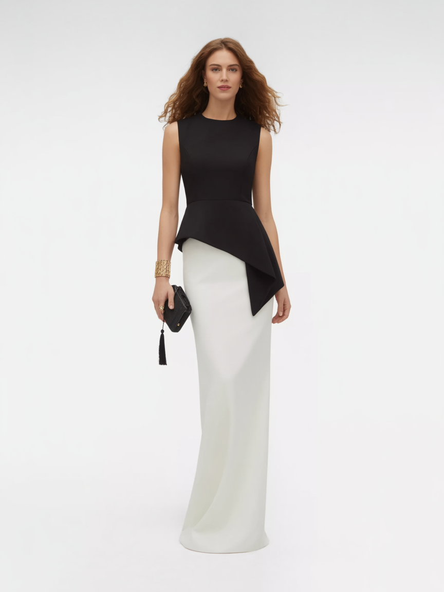 A woman stands against a plain background wearing a sleeveless black and white floor-length gown—perfect for black tie wedding guest dresses—holding a black clutch and accessorized with gold bracelets.