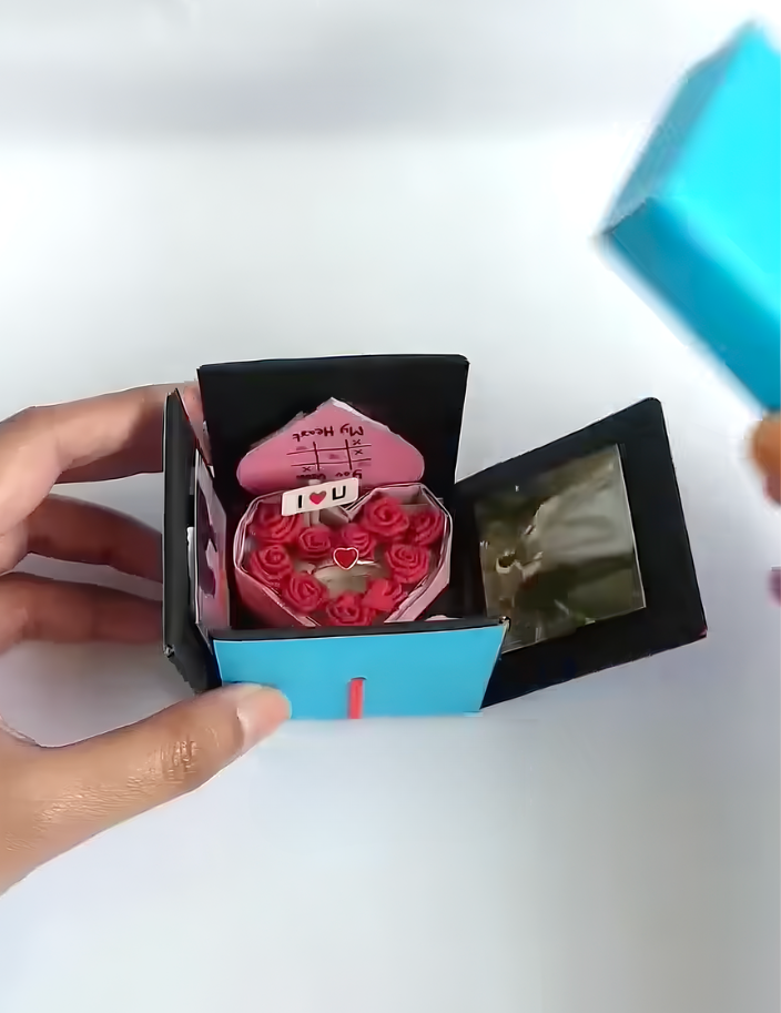 Jumping surprise box popping open with paper hearts
