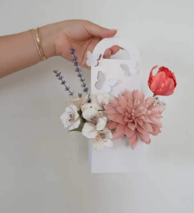 Two delicate paper flower gift boxes in oval and butterfly shapes