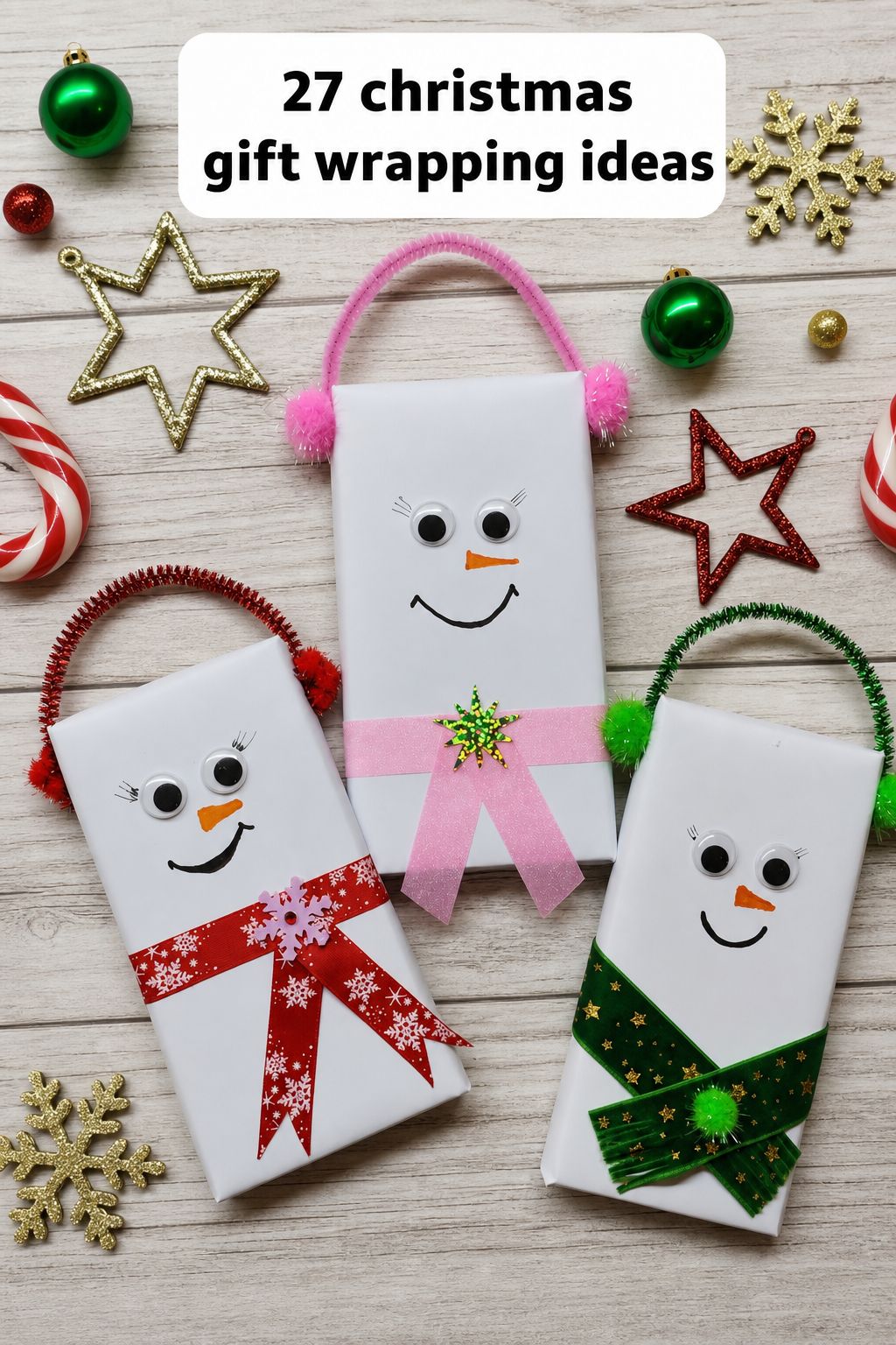 Three white gift boxes decorated with pipe cleaners, bows, and googly eyes to look like smiling snowmen, surrounded by Christmas ornaments and candy canes. Text: “27 Christmas gift wrapping ideas.” Discover creative gift wrapping inspiration and watch step-by-step videos for fun Christmas wrapping ideas!.